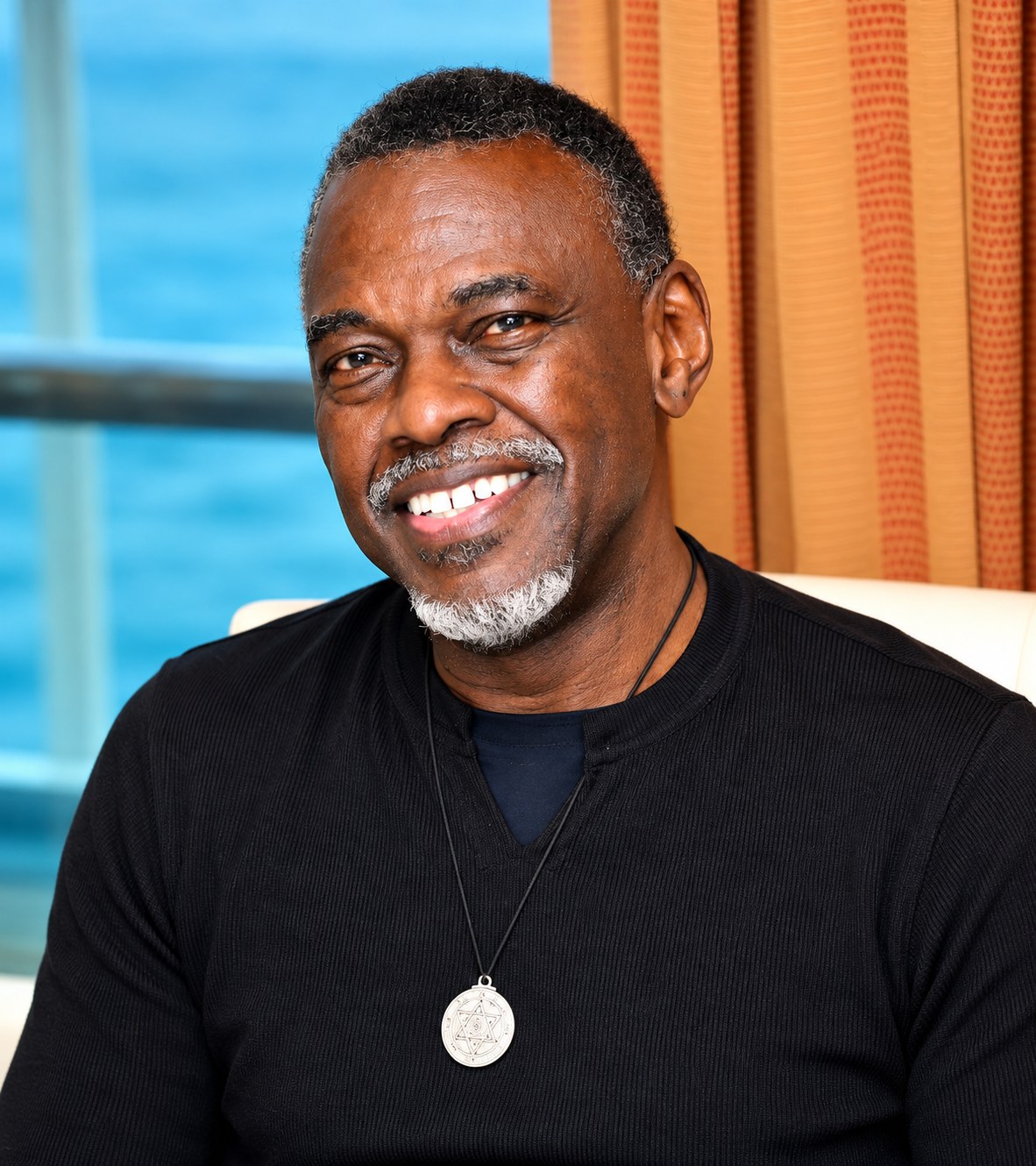 Leroy “Roy” Dingle smiling, with the ocean behind him